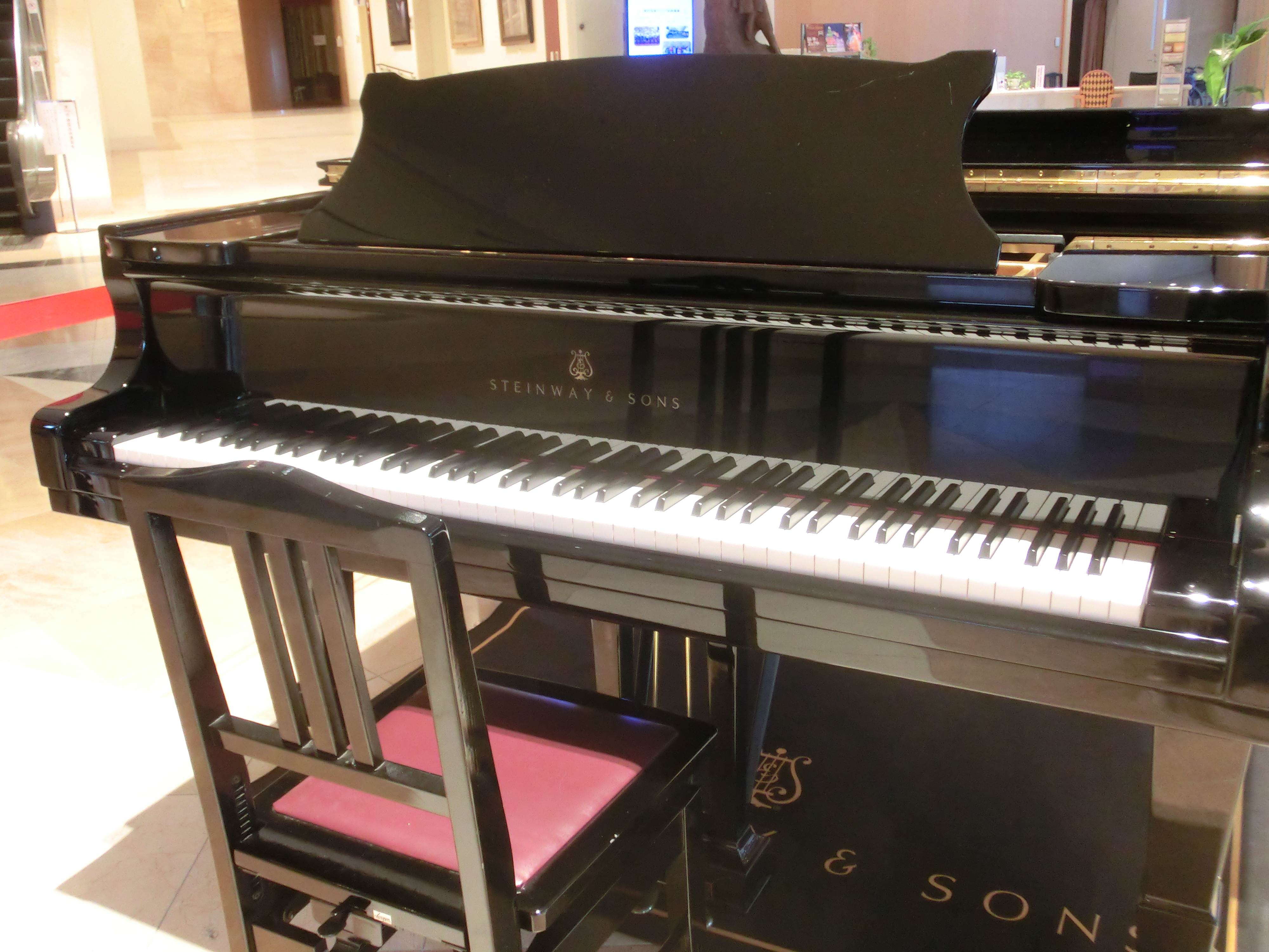 A black Steinway & Sons grand piano , placed in nagasaki brickhall.